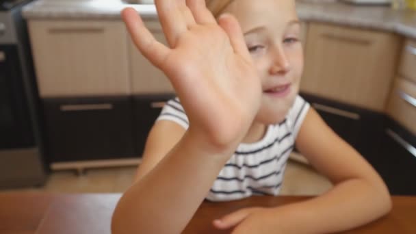 La petite fille est assise à la table — Video