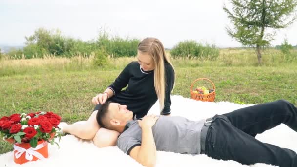 Young couple sitting on lawn — Stock Video