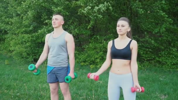 Couple practicing with a dumbbell — Stock Video