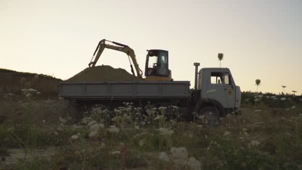 Bagger belädt einen Lastwagen — Stockvideo