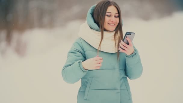 Beautiful Girl Looks Phone — Stock Video