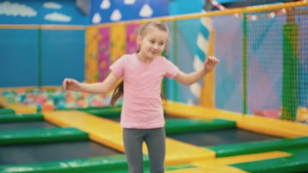 Klein meisje springen op trampoline — Stockvideo
