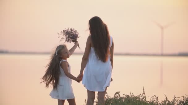Anne ve kızı deniz kıyısında durmak — Stok video