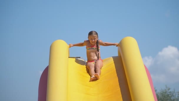 Menina vai para baixo o slide de água — Vídeo de Stock