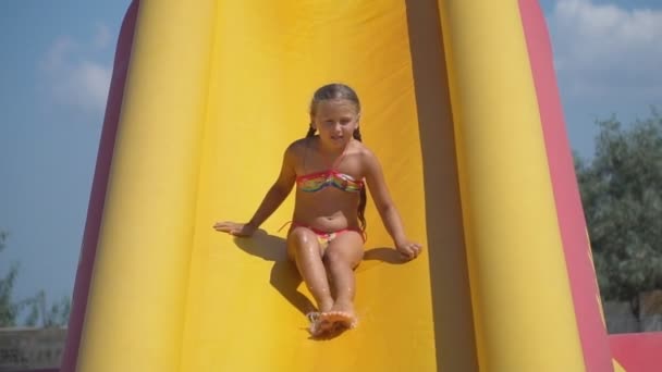 Menina desce de uma colina de amarelo — Vídeo de Stock