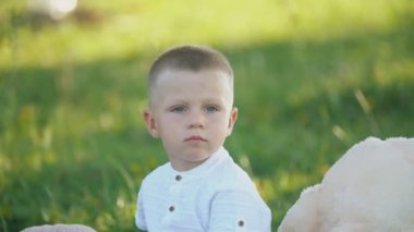 küçük çocuk oyuncak ayılar ile bir battaniye üzerinde oturan