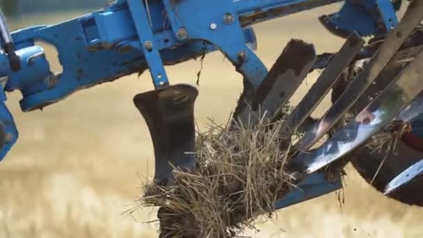 Трактор, вспахивающий землю современными плугами — стоковое видео