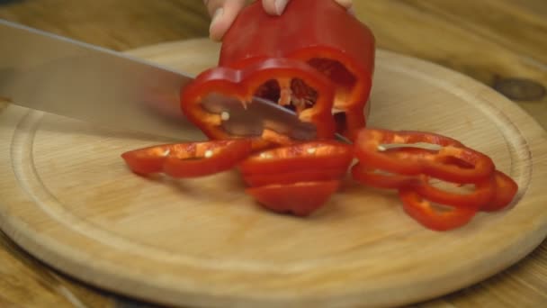 Cutting red pepper on a wooden board — Stock Video