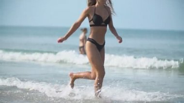 Mayo giyen bir kız derin bir denizde koşar.