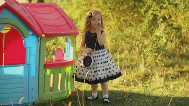 Little girl straightens hair with hand — Stock Video