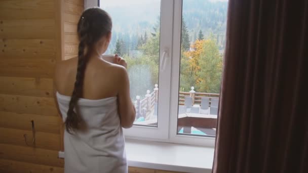 Meisje drinkt thee bij het raam — Stockvideo