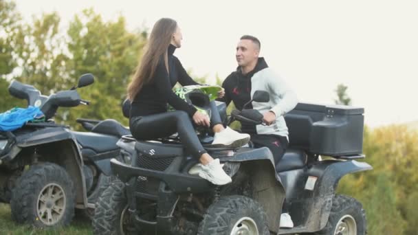 Couple kisses standing on ATVs — Stock Video