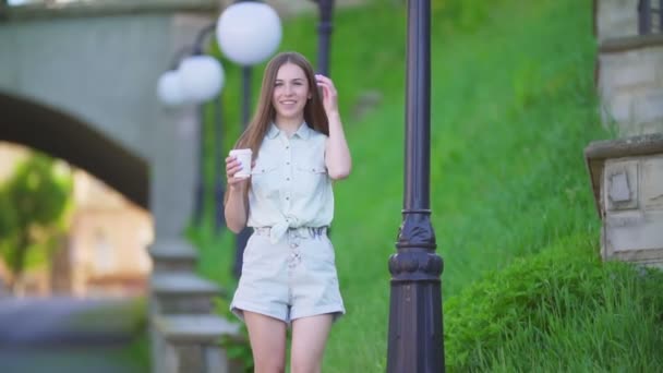 Belle fille en short et une tasse en plastique — Video