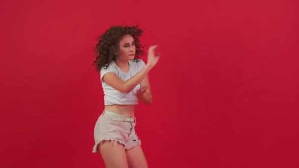 Mulher dançando em um fundo vermelho — Vídeo de Stock