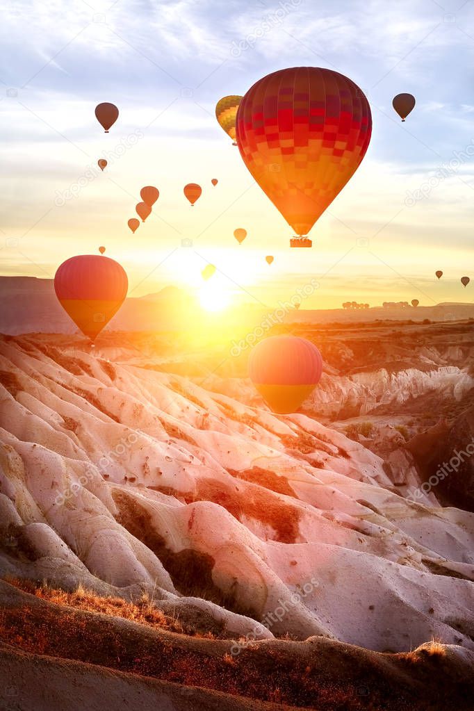 Color balloon at sunrise. Landscape. The Valley Of Love. The sun's rays hit the camera lens.