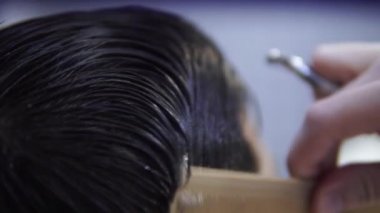 Berber fırça ile Berber dükkanında müşteri ıslak saç tarar, closeup
