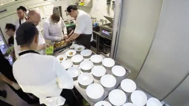 商業キッチンで食べ物を準備するシェフの忙しいチームの時間経過 — ストック動画