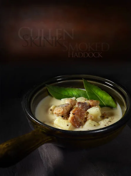 Original and authentic Cullen Skink chowder served with fresh bay leaves and shot against a dark rustic background with generous accommodation for copy space. — Stock Image Original Authentic Cullen Skink Chowder Served Fresh Bay Leaves Shot Royalty Free Stock Images