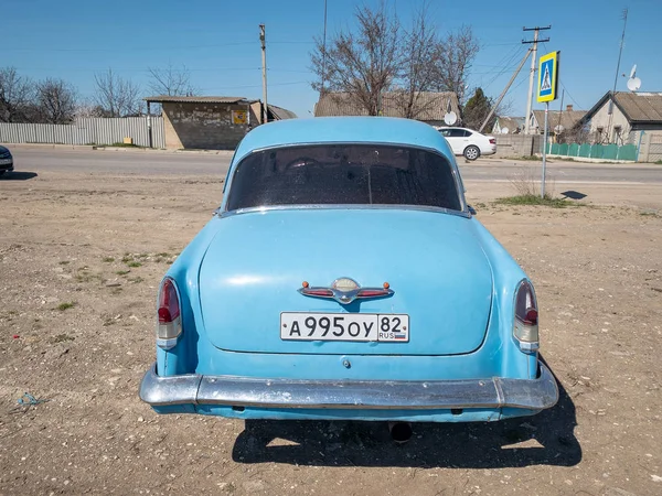 Sevastopol, Republic of Crimea - March 23, 2019: Blue old soviet car GAZ M21 Volga / GAZ-21 oldtimer parked on the road in spring sunny weather