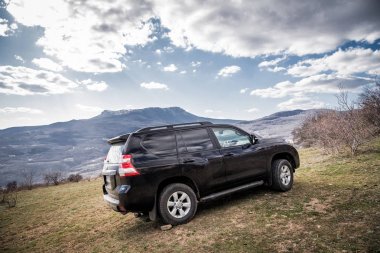 Alushta, Kırım Cumhuriyeti - Mart 23, 2019: Siyah off-road araba Toyota Land Cruiser Prado doğada park