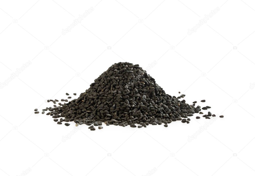 Black cumin heap on white background. A pile of nigella sativa seed.