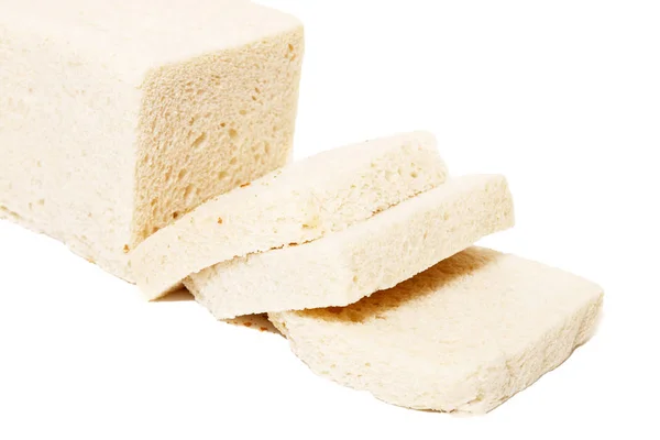 Traditional rectangular loaf of bread on white background.