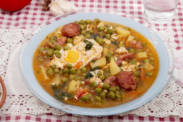Traditional portuguese culinary meal of green peas with egg, potatoes and chorizo.