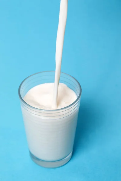 Hälla Mjölk Glas Isolerade Blå Bakgrund — Stockfoto