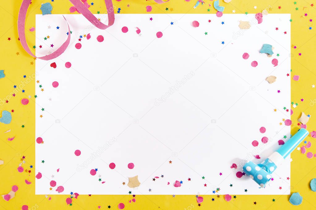 carnival confetti and ribbons on white paper.