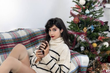 Young girl on sofa at christmas