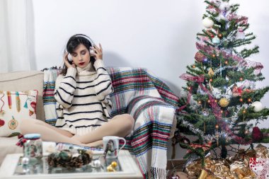 Young girl on sofa with headphones