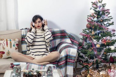 Young girl on sofa with headphones