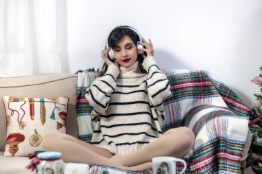 Young girl on sofa with headphones