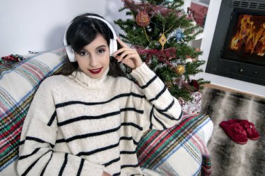 Young girl on sofa with headphones
