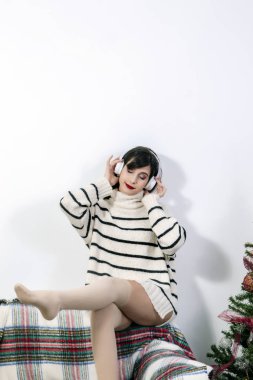 Young girl on sofa with headphones