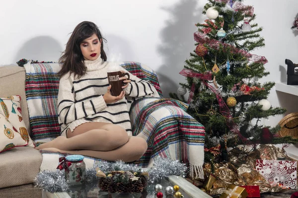 Young girl on sofa at christmas