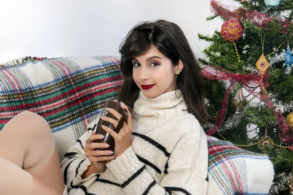 Young girl on sofa at christmas