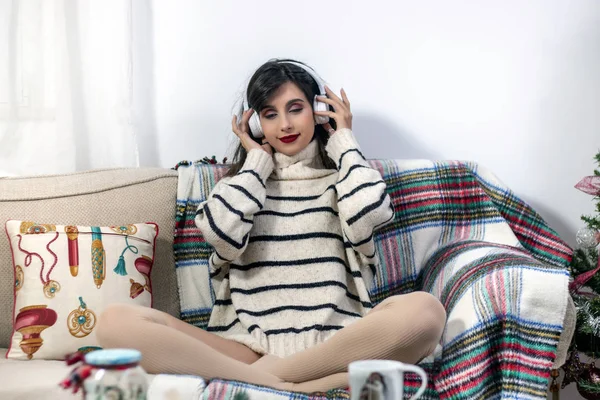 Young girl on sofa with headphones
