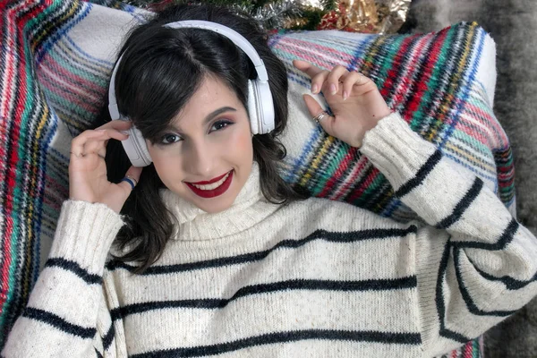 Young girl on sofa with headphones