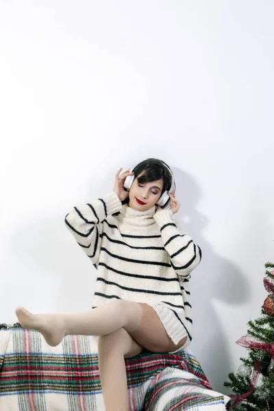 Young girl on sofa with headphones