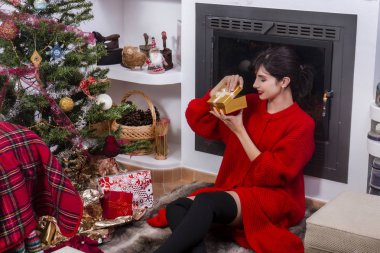 Young girl checking christmas gift
