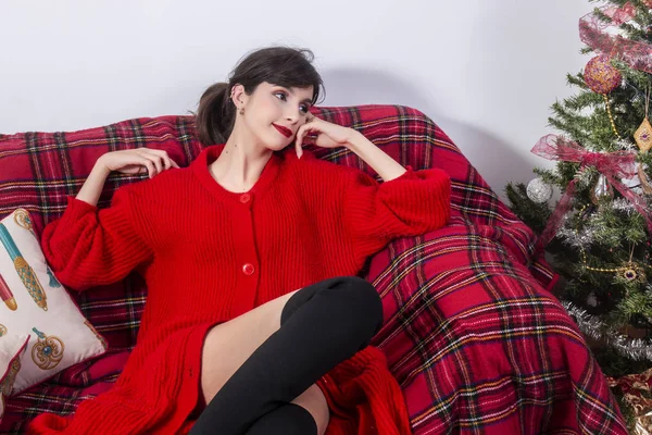 Young girl on sofa at christmas — Stock Photo, Image