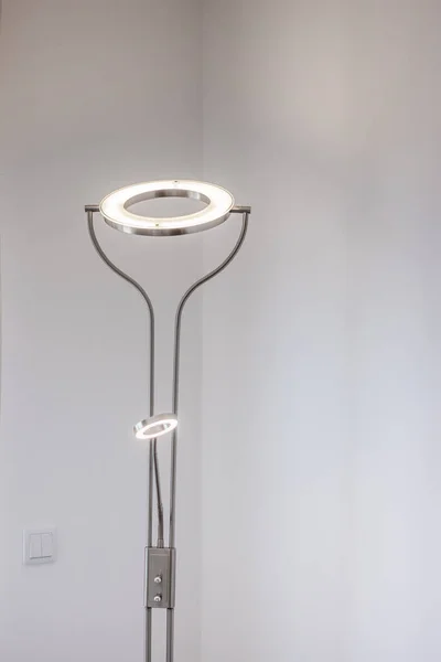 modern luxury light stand lamp on a white corner wall in the living room.