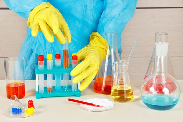 Scientist in rubber gloves doing chemical experiments in the laboratory