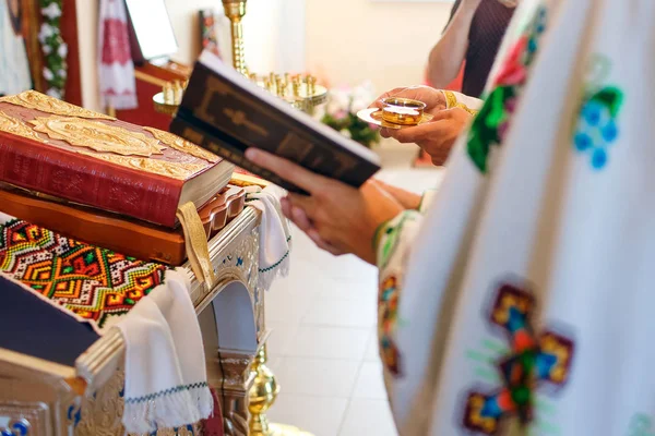 Cerimônia de casamento na Igreja Ortodoxa nas mãos da Bíblia e óleo sagrado — Fotografia de Stock