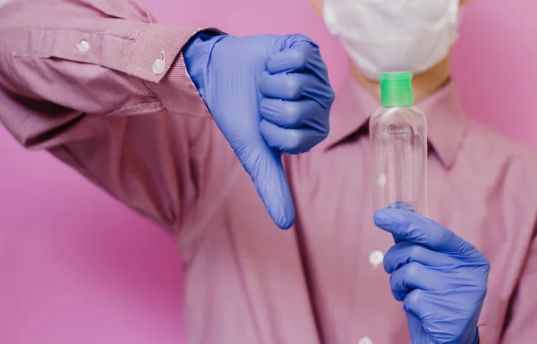 Guy Medical Glove Holds Empty Sanitizer Thumb Pink Background — Stock Photo, Image