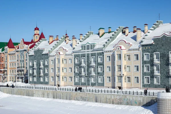 Waterfront houses in the city of Yoshkar-Ola, in Russia. Winter snow. Sights of the city of Yoshkar-Ola. Colorful houses.