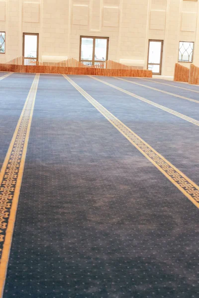 Blue carpet in the mosque. Prayer room. Window.