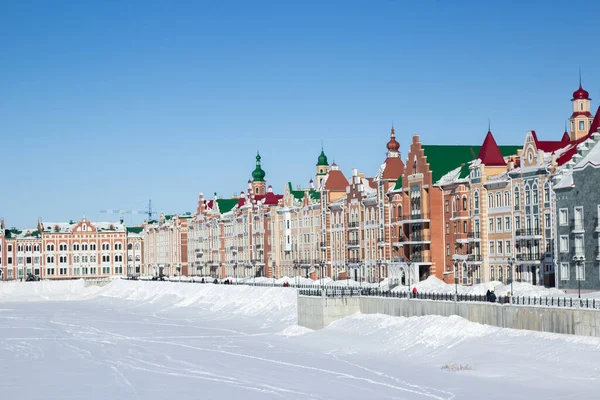 Waterfront houses in the city of Yoshkar-Ola, in Russia. Winter snow. Sights of the city of Yoshkar-Ola. Colorful houses.