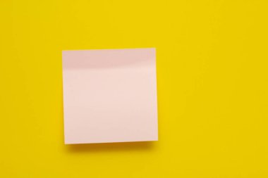 Sarı arka planda pembe etiket. Yapışkan kenarlı bir çıkartma. Yazıtlar için etiket. Boşluğu kopyala.
